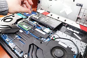 A laptop having its internal components upgraded at Buzztime Electronics